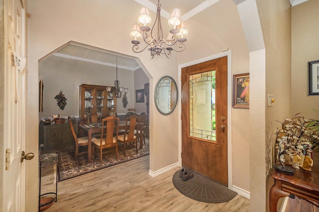 5625 Guadalajara Dr, North Richland Hills, TX 76180 - foyer entrance with a chandelier, arched walkways, wood finished floors, baseboards, and a towering ceiling
