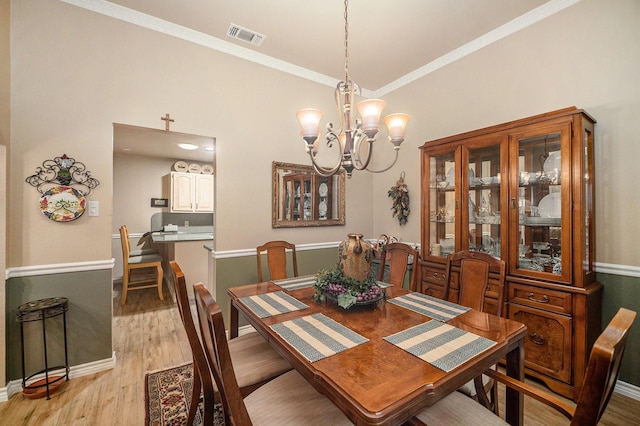 5625 Guadalajara Dr, North Richland Hills, TX 76180 - dining room with a chandelier, light wood-type flooring, crown molding, and baseboards