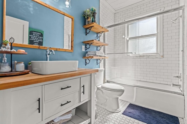 bathroom featuring shower / bath combination with glass door, toilet, and vanity