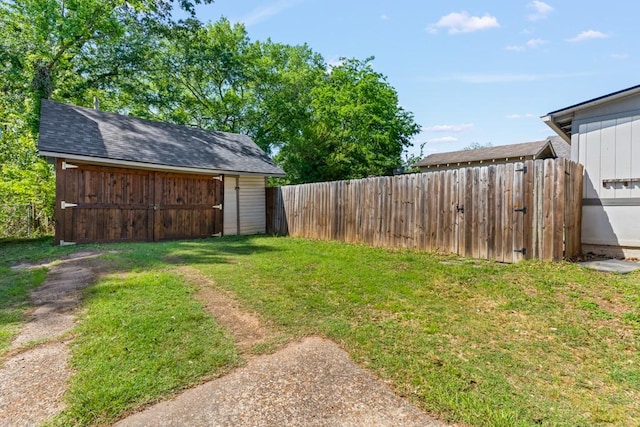 view of yard featuring fence, an outbuilding, and a storage shed