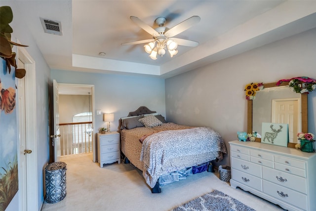 3932 Harrison Ct, Carrollton, TX 75010 - bedroom with ceiling fan, visible vents, a raised ceiling, and light colored carpet