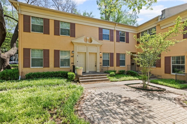 view of property featuring brick siding