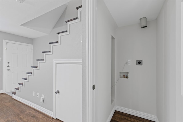 interior space featuring baseboards and wood finished floors
