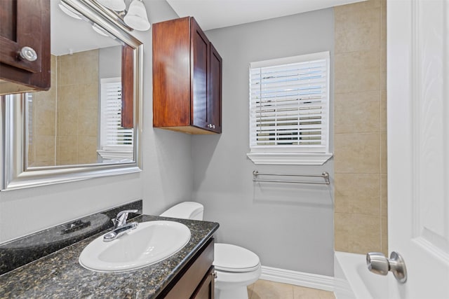 bathroom with toilet, vanity, and tile patterned floors