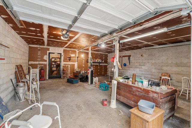 1302 E 1st St, Mount Pleasant, TX 75455 - garage with concrete block wall and a garage door opener