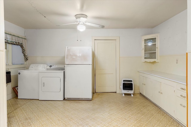 1302 E 1st St, Mount Pleasant, TX 75455 - laundry area featuring heating unit, washer and dryer, wainscoting, cabinet space, and ceiling fan