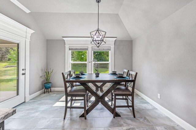 5003 Frio Dr, Granbury, TX 76048 - dining space with vaulted ceiling, baseboards, light stone finish floors, and a chandelier