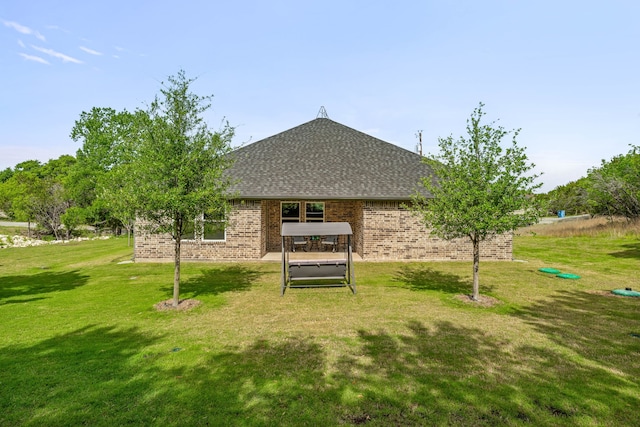 5003 Frio Dr, Granbury, TX 76048 - rear view of house featuring a lawn, brick siding, and a shingled roof