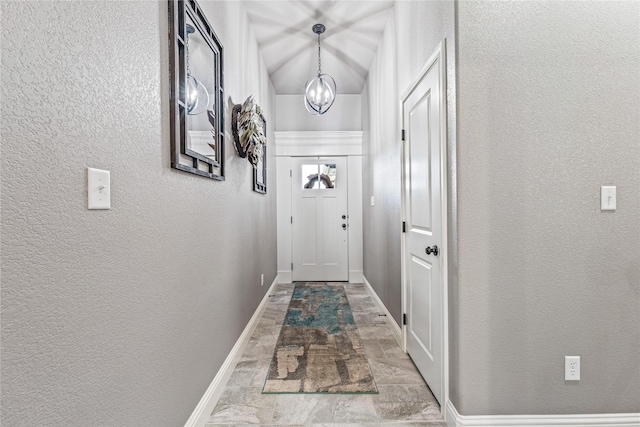 5003 Frio Dr, Granbury, TX 76048 - entryway featuring a chandelier, a textured wall, and baseboards