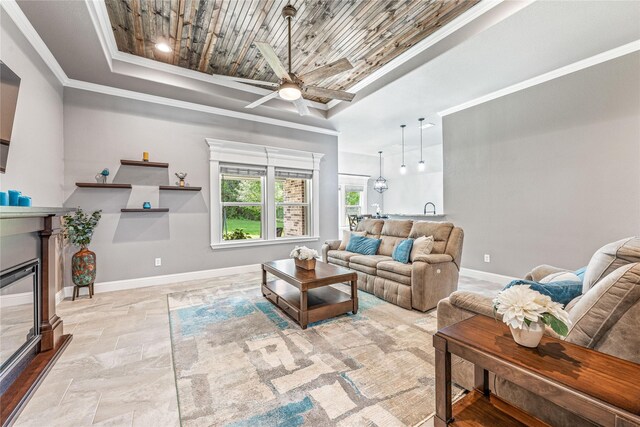 5003 Frio Dr, Granbury, TX 76048 - living area with a raised ceiling, ceiling fan, wood ceiling, baseboards, and a glass covered fireplace