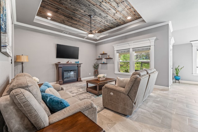 5003 Frio Dr, Granbury, TX 76048 - living room featuring a raised ceiling, a glass covered fireplace, ceiling fan, baseboards, and wood ceiling
