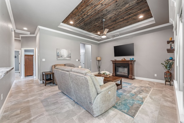 5003 Frio Dr, Granbury, TX 76048 - living area with a raised ceiling, ceiling fan, baseboards, a glass covered fireplace, and ornamental molding