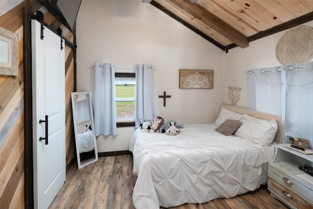 bedroom featuring lofted ceiling with beams, wood finished floors, wood ceiling, and a barn door