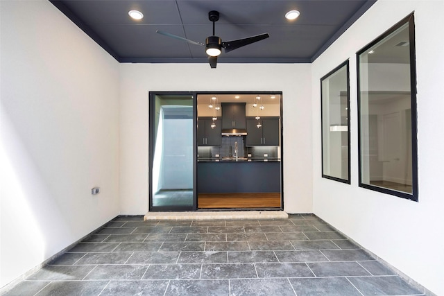 7312 Collin Mckinney Pkwy, Mckinney, TX 75070 - property entrance with stucco siding, ceiling fan, and a sink