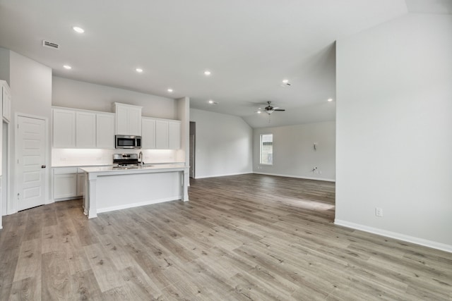 kitchen with light wood-style flooring, open floor plan, visible vents, white cabinetry, and appliances with stainless steel finishes