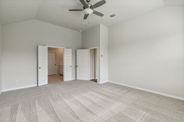 unfurnished bedroom featuring carpet, visible vents, a ceiling fan, ensuite bath, and baseboards