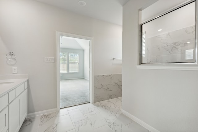 bathroom with vanity, baseboards, and marble finish floor