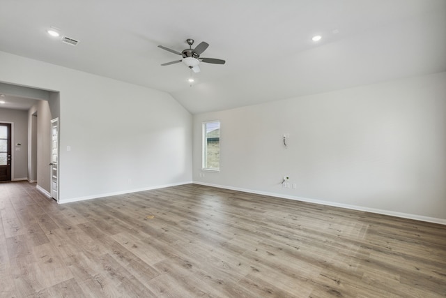 unfurnished room with vaulted ceiling, a ceiling fan, baseboards, and wood finished floors