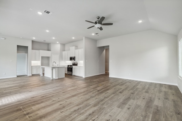 unfurnished living room with baseboards, recessed lighting, light wood-style floors, and ceiling fan