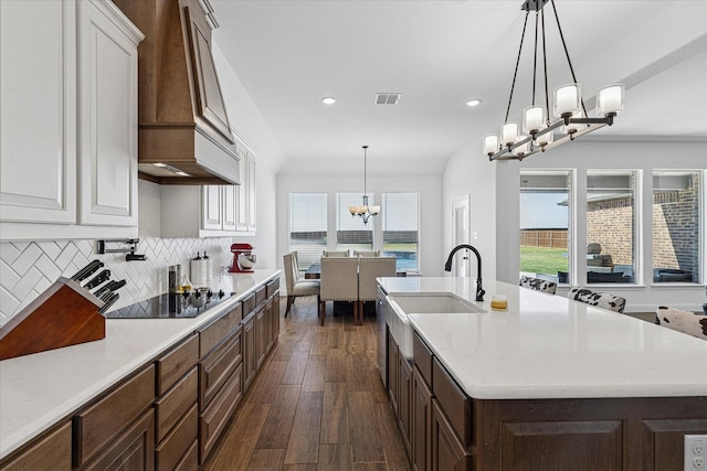 12816 Rocky Top Rd, Godley, TX 76044 - kitchen featuring white cabinets, black electric cooktop, a kitchen island with sink, dark wood finished floors, and a chandelier