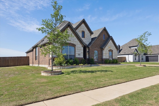 12816 Rocky Top Rd, Godley, TX 76044 - french country style house featuring brick siding, fence, stone siding, and a front yard