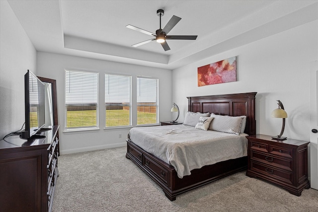 12816 Rocky Top Rd, Godley, TX 76044 - bedroom featuring a raised ceiling, ceiling fan, baseboards, and light carpet