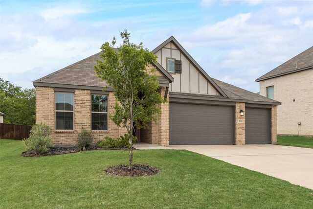 english style home with board and batten siding, driveway, brick siding, and a garage