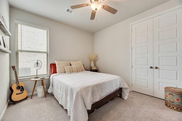 bedroom with light colored carpet, multiple windows, and visible vents