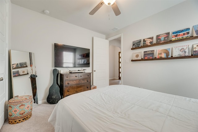 carpeted bedroom with baseboards, visible vents, arched walkways, and ceiling fan