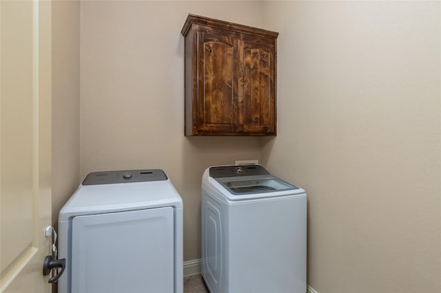laundry room featuring cabinet space and independent washer and dryer