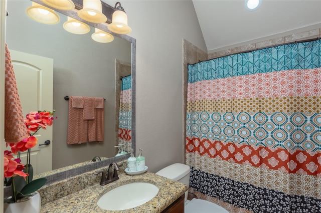 full bathroom featuring curtained shower, lofted ceiling, toilet, and vanity
