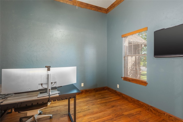 office space with baseboards and wood finished floors