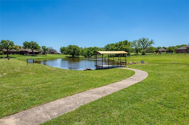 view of home's community featuring a lawn and a water view