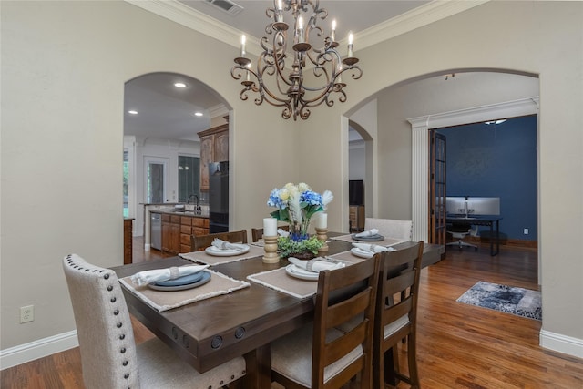 100 Meadow Arbor Dr, Weatherford, TX 76085 - dining space with arched walkways, ornamental molding, wood finished floors, and a chandelier