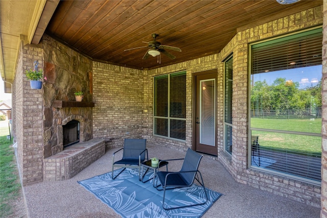 doorway to property featuring brick siding, a yard, roof with shingles, and stone siding