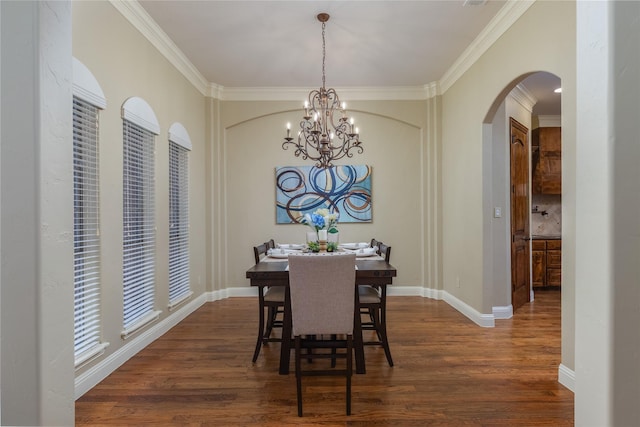 dining space with arched walkways, dark wood-style flooring, crown molding, and a notable chandelier