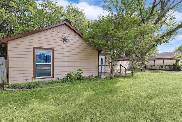 exterior space with fence and a front lawn