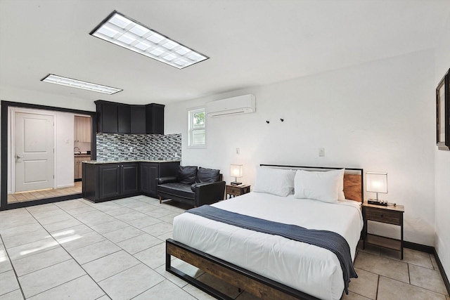 bedroom with light tile patterned floors, baseboards, and a wall unit AC