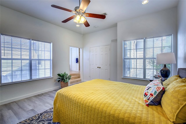 bedroom featuring multiple windows, wood finished floors, visible vents, and recessed lighting