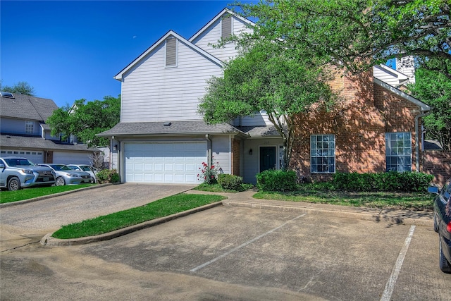 view of front of property featuring brick siding and a garage