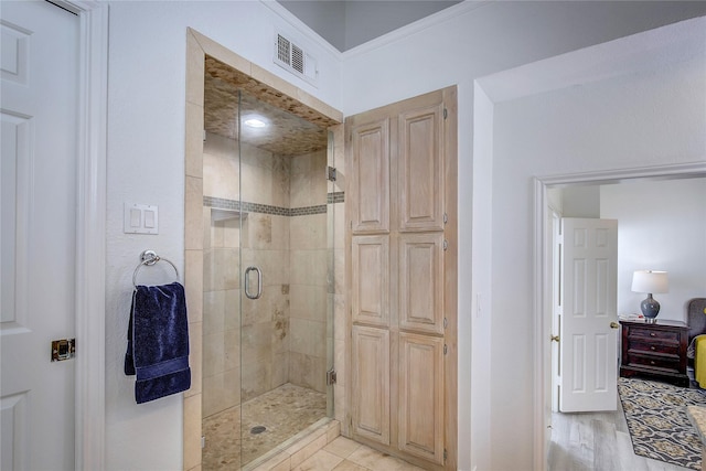 full bathroom featuring baseboards, visible vents, and a shower stall