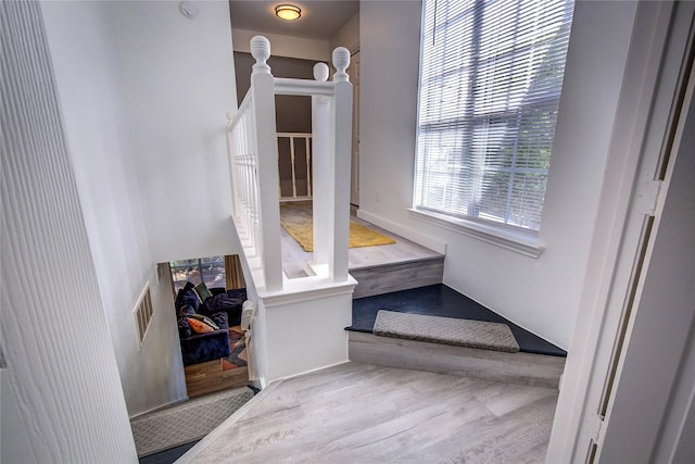stairs featuring visible vents and wood finished floors
