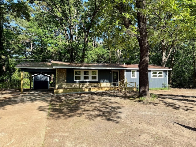 369 County Road 2119, Quitman, TX 75783 - ranch-style house featuring driveway, a carport, board and batten siding, and a porch