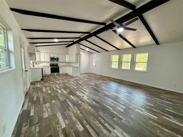 369 County Road 2119, Quitman, TX 75783 - unfurnished living room with vaulted ceiling with beams, baseboards, a sink, and dark wood finished floors