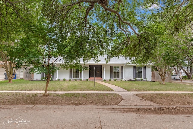 ranch-style home with brick siding and a front lawn