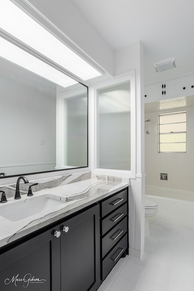 bathroom with vanity, bathtub / shower combination, toilet, tile patterned flooring, and visible vents