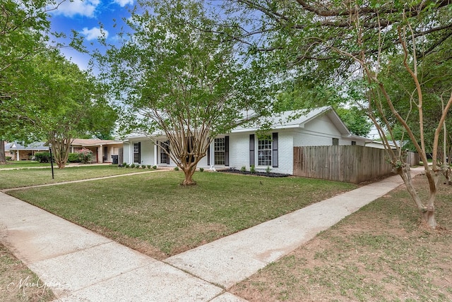 single story home with fence, a front lawn, and brick siding