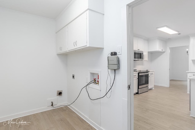 washroom featuring baseboards, light wood-style floors, hookup for a washing machine, cabinet space, and electric dryer hookup
