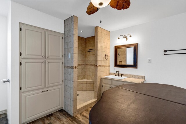 13122 Lipan Hwy, Lipan, TX 76462 - bathroom featuring ceiling fan, walk in shower, vanity, and wood finished floors