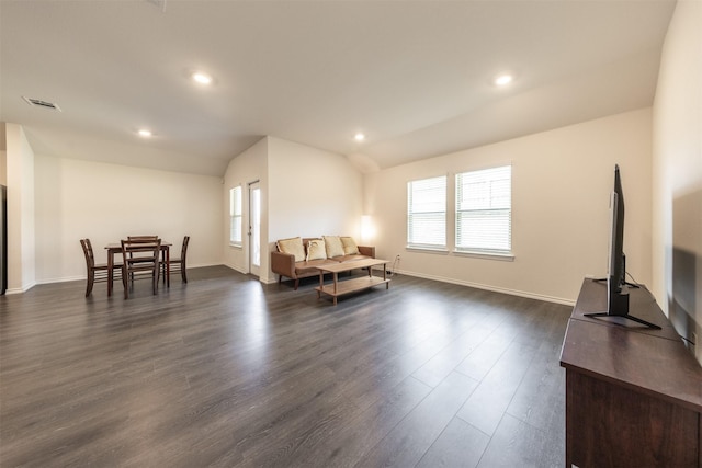 living room featuring baseboards, vaulted ceiling, visible vents, and dark wood-style floors